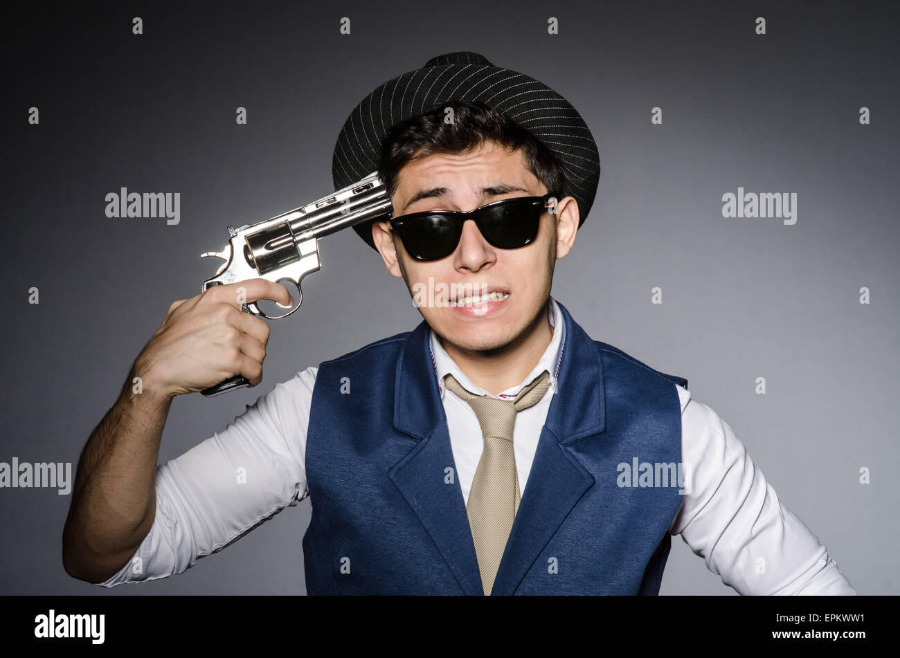 Man wearing sunglasses with gun Stock Photo Alamy