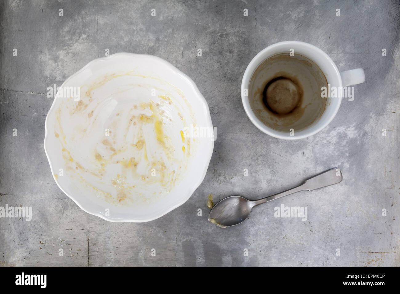 Finished breakfast with porridge and coffee remains Stock Photo