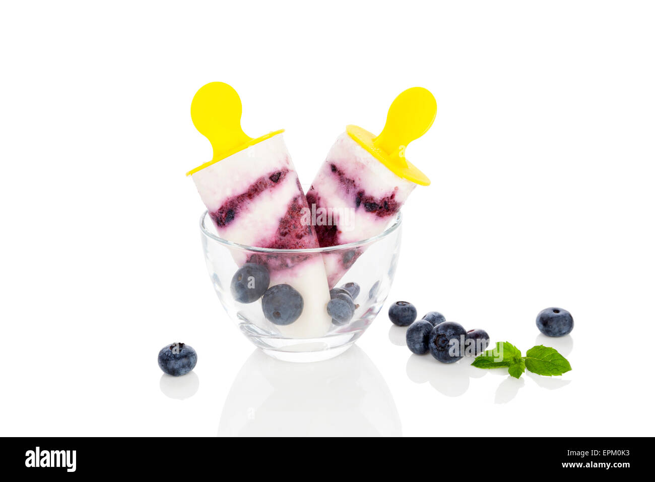 Fruit ice lolly with fresh blueberries and mint leaves isolated on