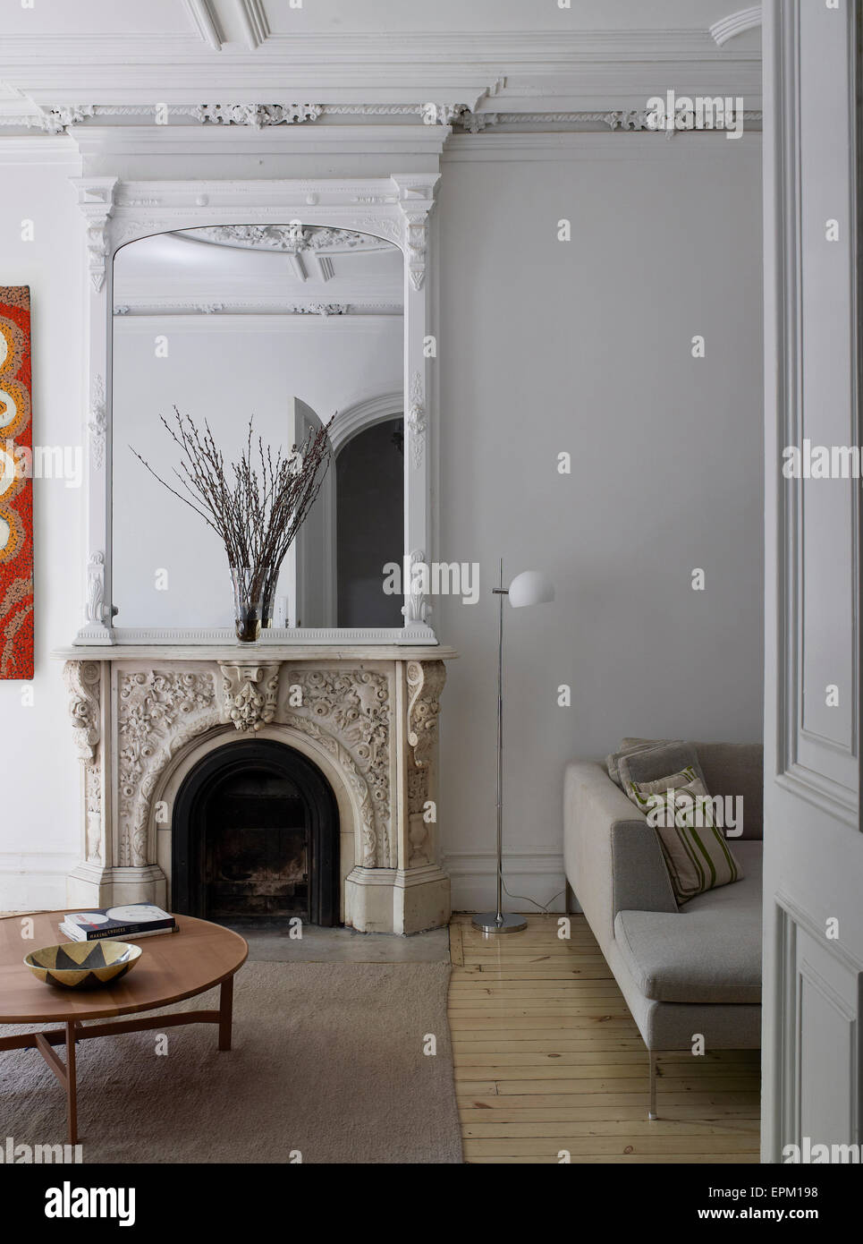 Fireplace And Mirror In Large Living Room With White Plastered