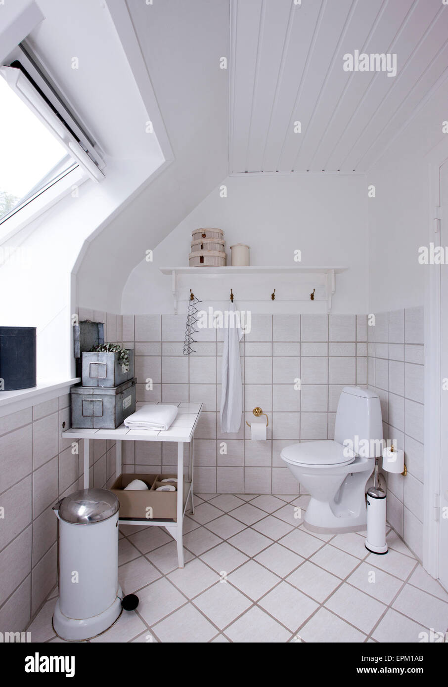 Tiled bathroom with dormer window in Hanne Davidsen home renovation, Silkesborg, Denmark. Stock Photo