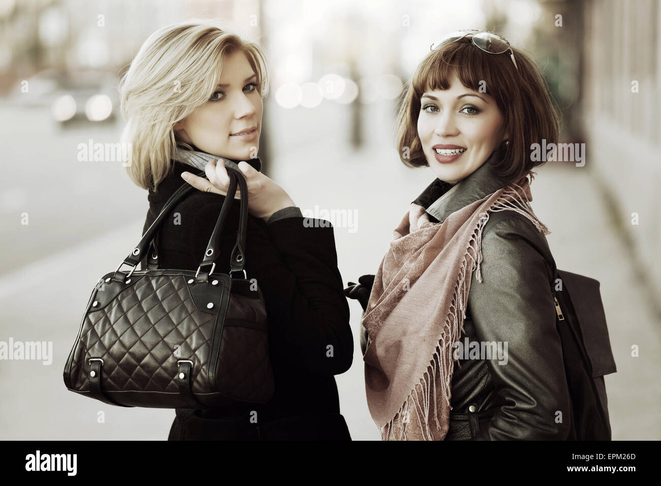 Two happy young women on the city street Stock Photo - Alamy