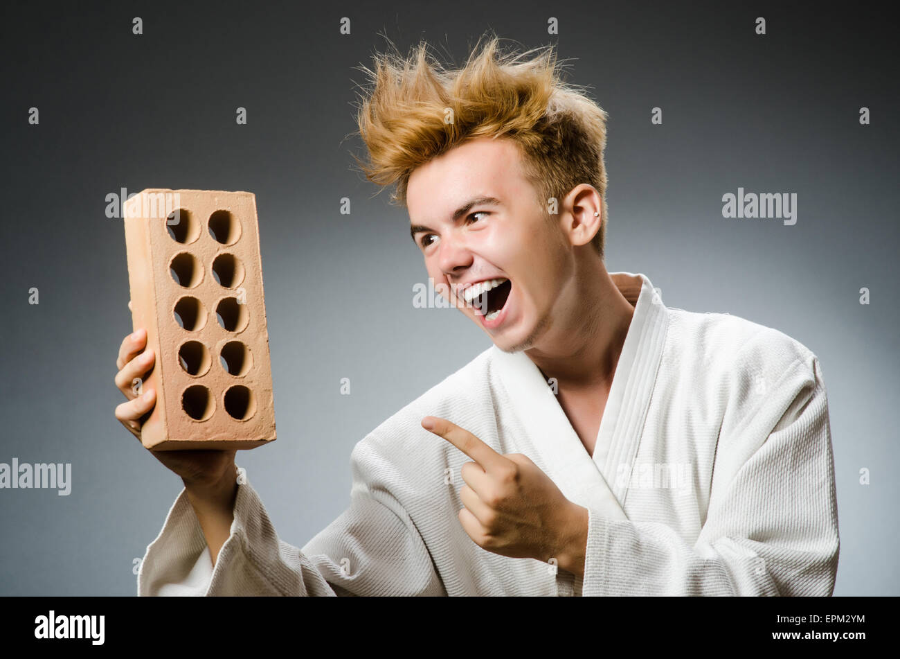 Funny karate fighter with clay brick Stock Photo - Alamy