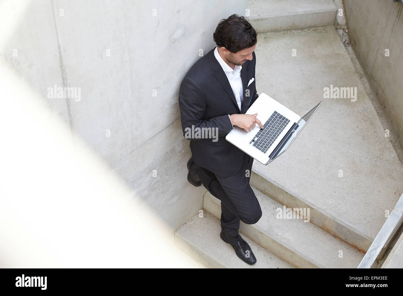 Businessman using laptop in a modern building Stock Photo