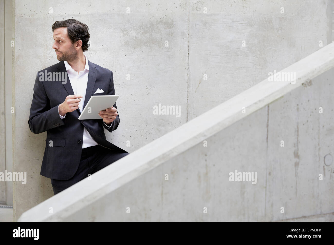 Businessman with digital tablet in a modern building Stock Photo