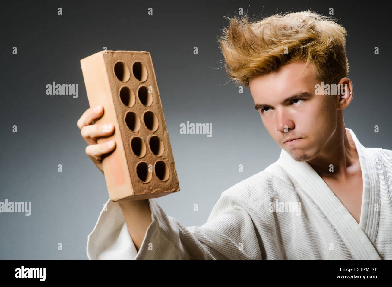 Funny karate fighter with clay brick Stock Photo - Alamy