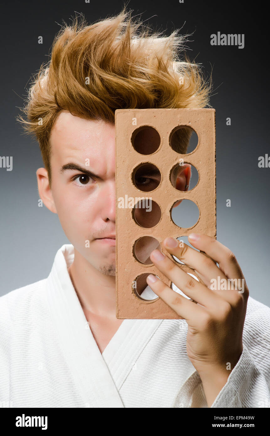 Funny karate fighter with clay brick Stock Photo - Alamy