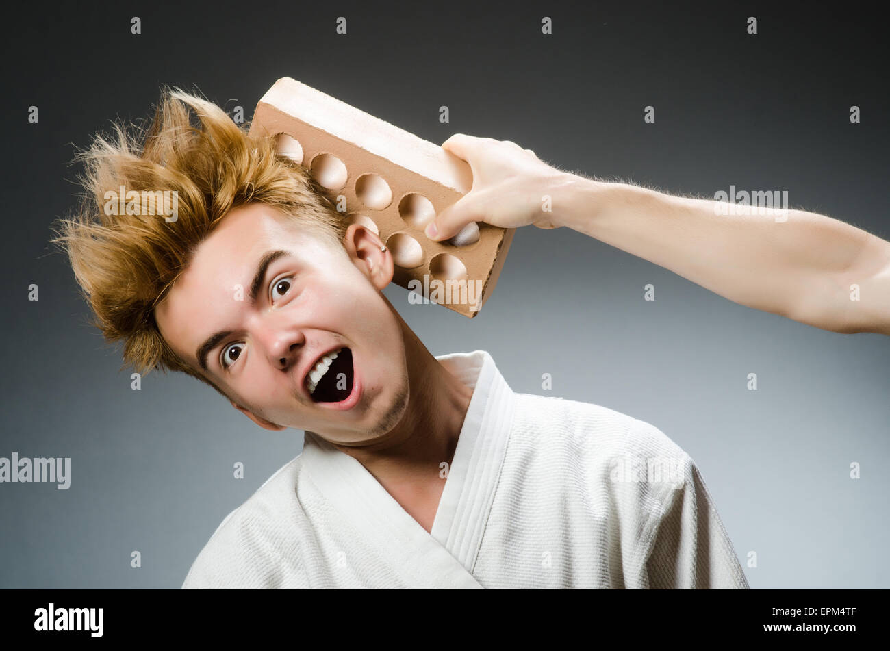 Funny karate fighter with clay brick Stock Photo - Alamy