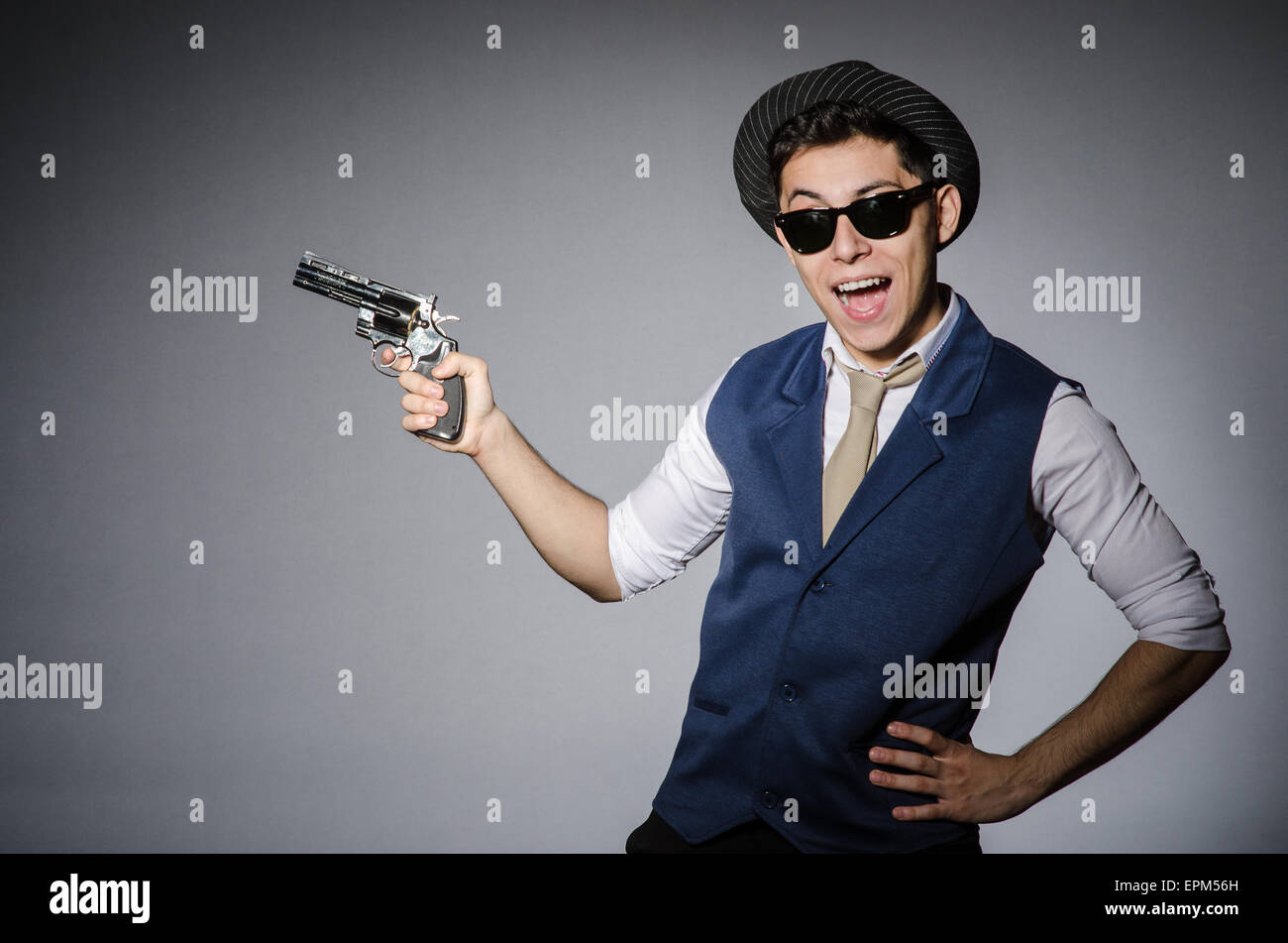 Man wearing sunglasses with gun Stock Photo Alamy
