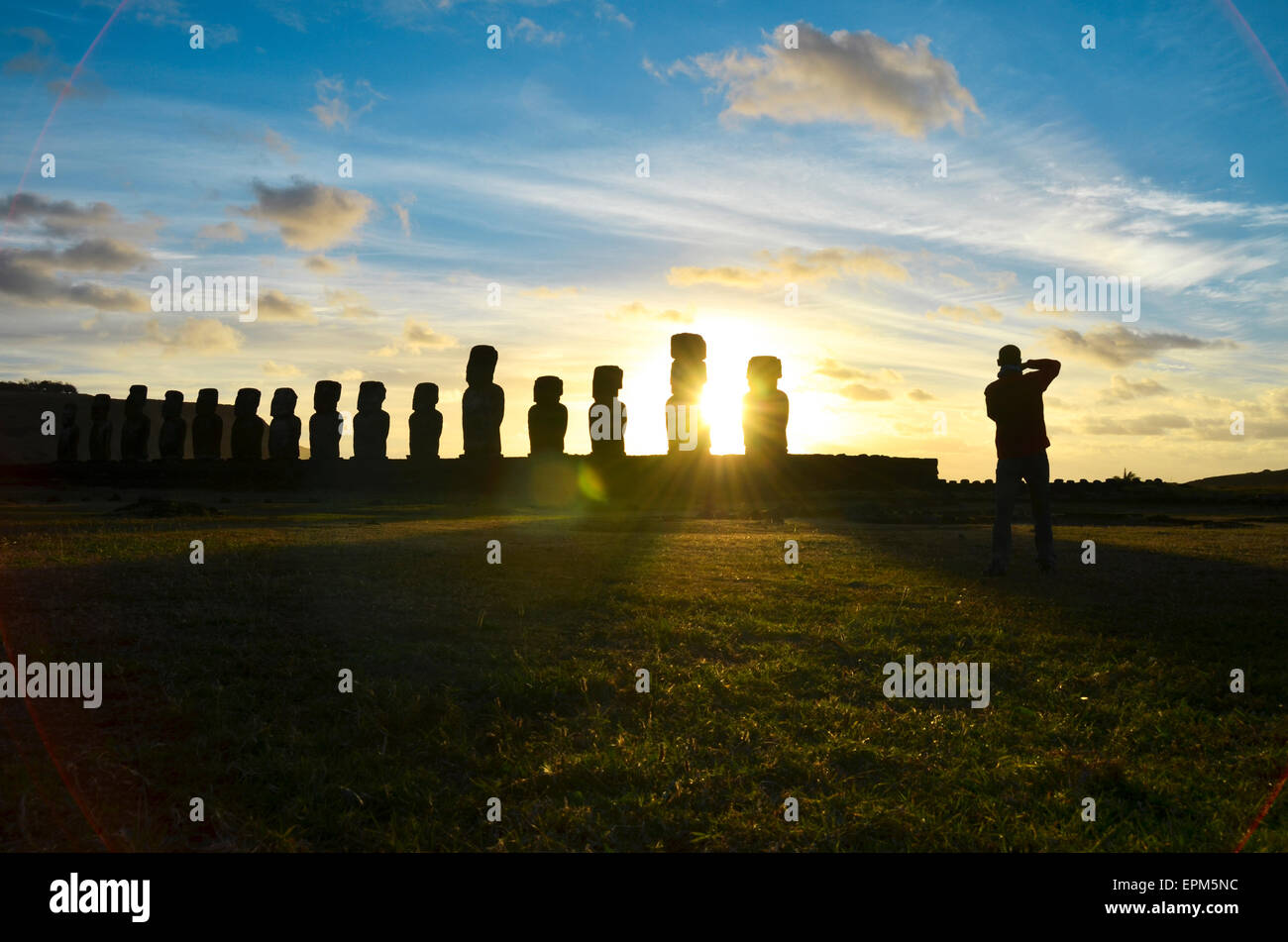 Chile, Easter Island, row of moais at Ahu Tongariki at sunset, Tourist photographing Stock Photo
