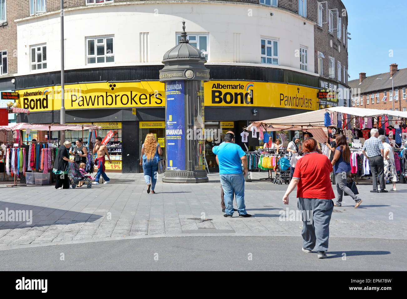 Barking town centre people shoppers in pedestrianised street scene with Albemarle & Bond pawnbroker pawn shop and market stalls East London England UK Stock Photo