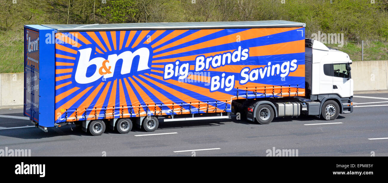 Side view b&m retail supermarket business supply chain delivery lorry truck & articulated trailer B & M  brand advertising & logo graphic UK motorway Stock Photo