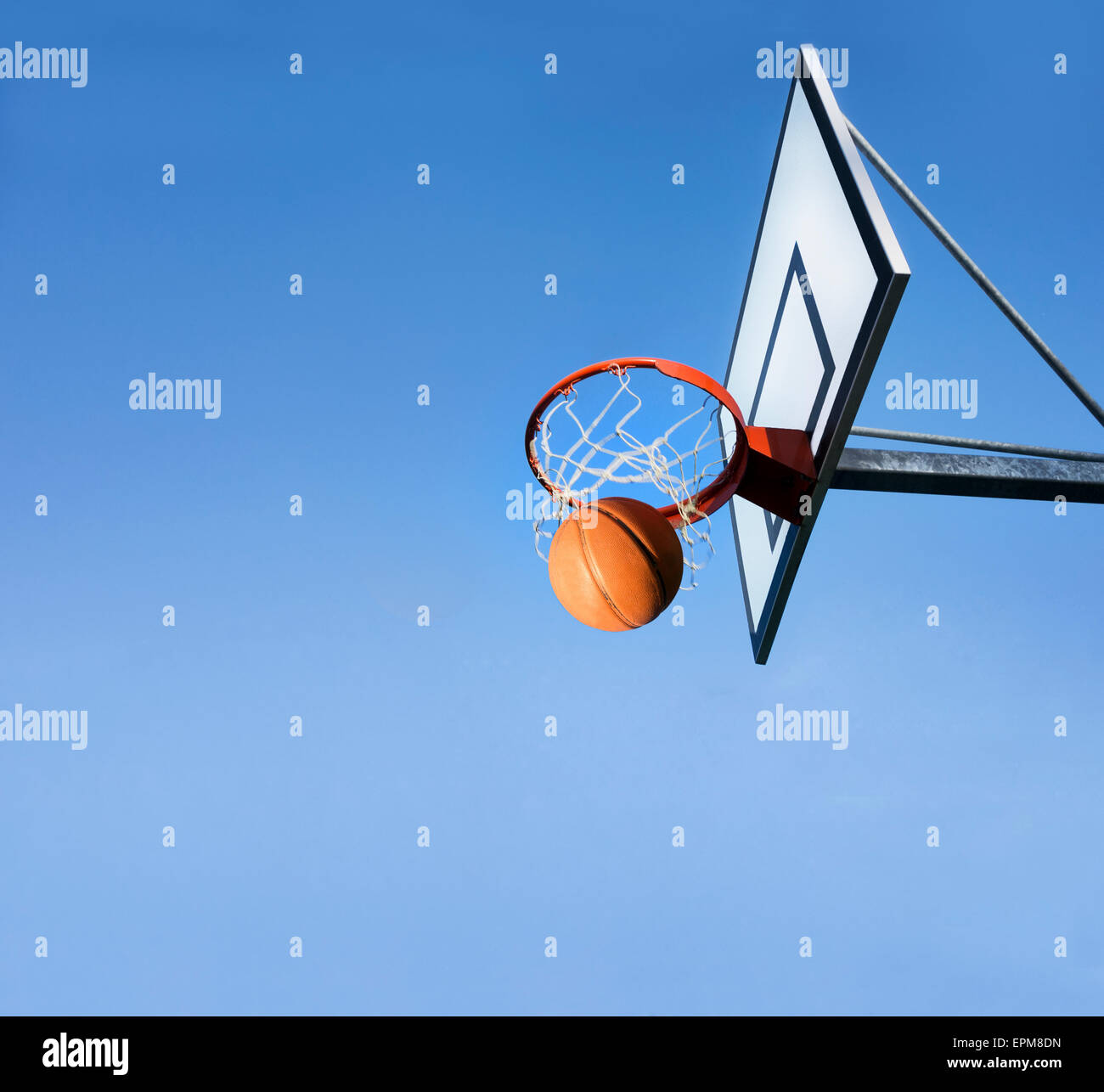 Basketball going through hoop Stock Photo Alamy