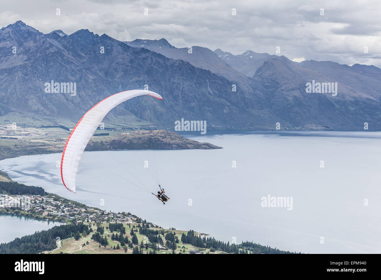 Paragliding with instructor above lake Wakatipu, Queensland, Otago, New Zealand Stock Photo