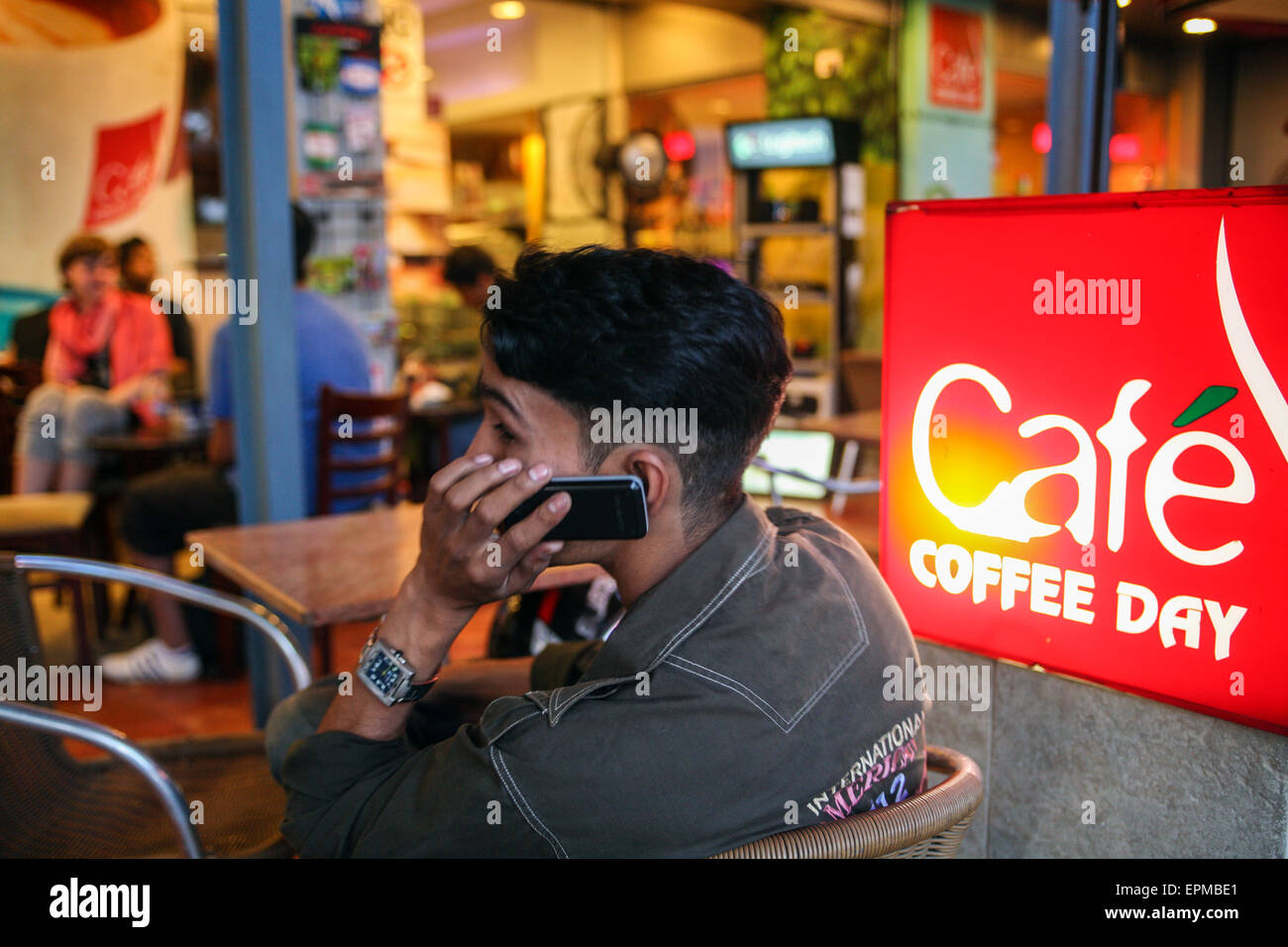 Young trendy Indians at coffee shop, Coffee Day, a national chain near