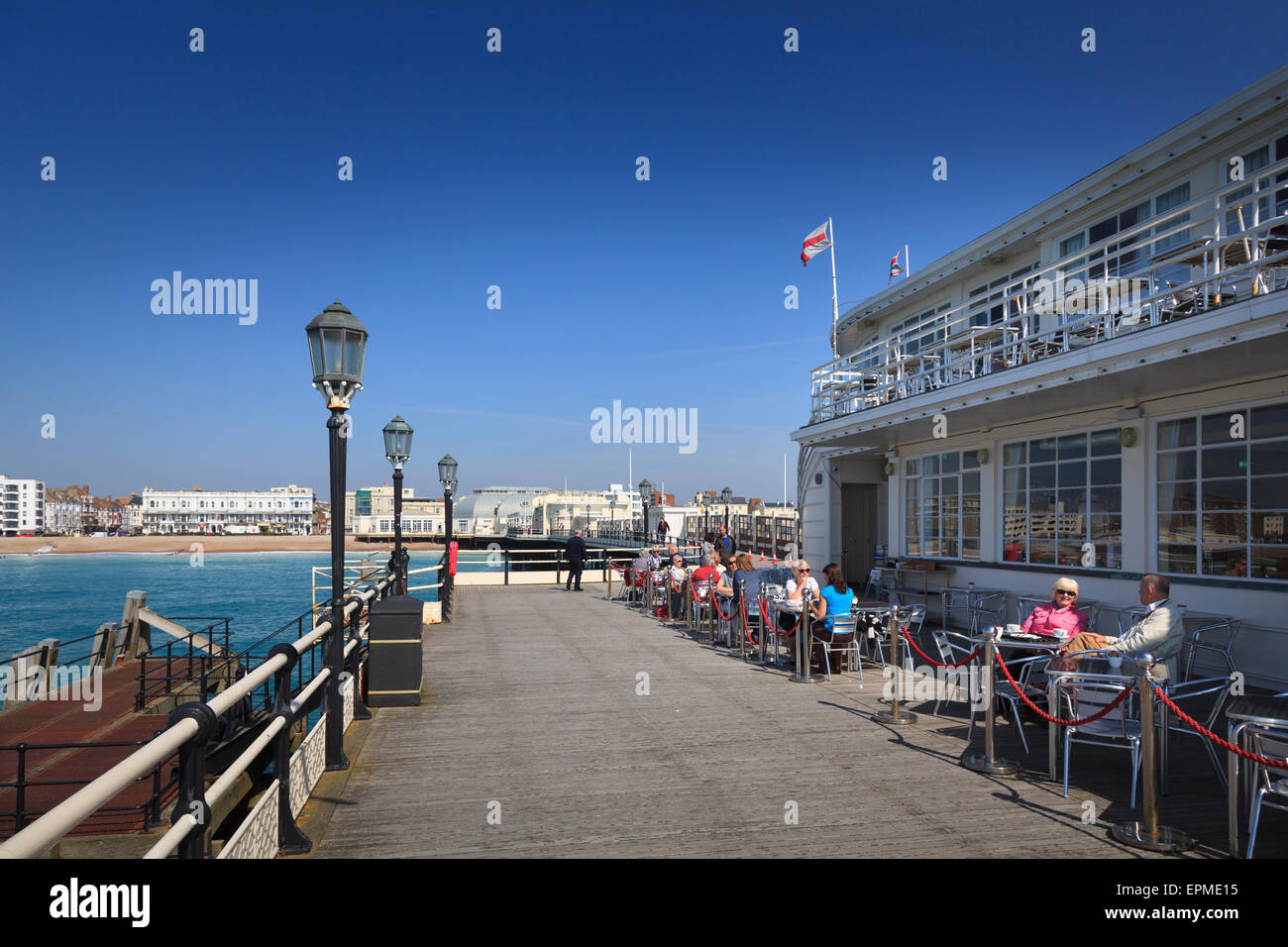 Customers at tables outside Worthing Pier Southern Pavilion Cafe Stock