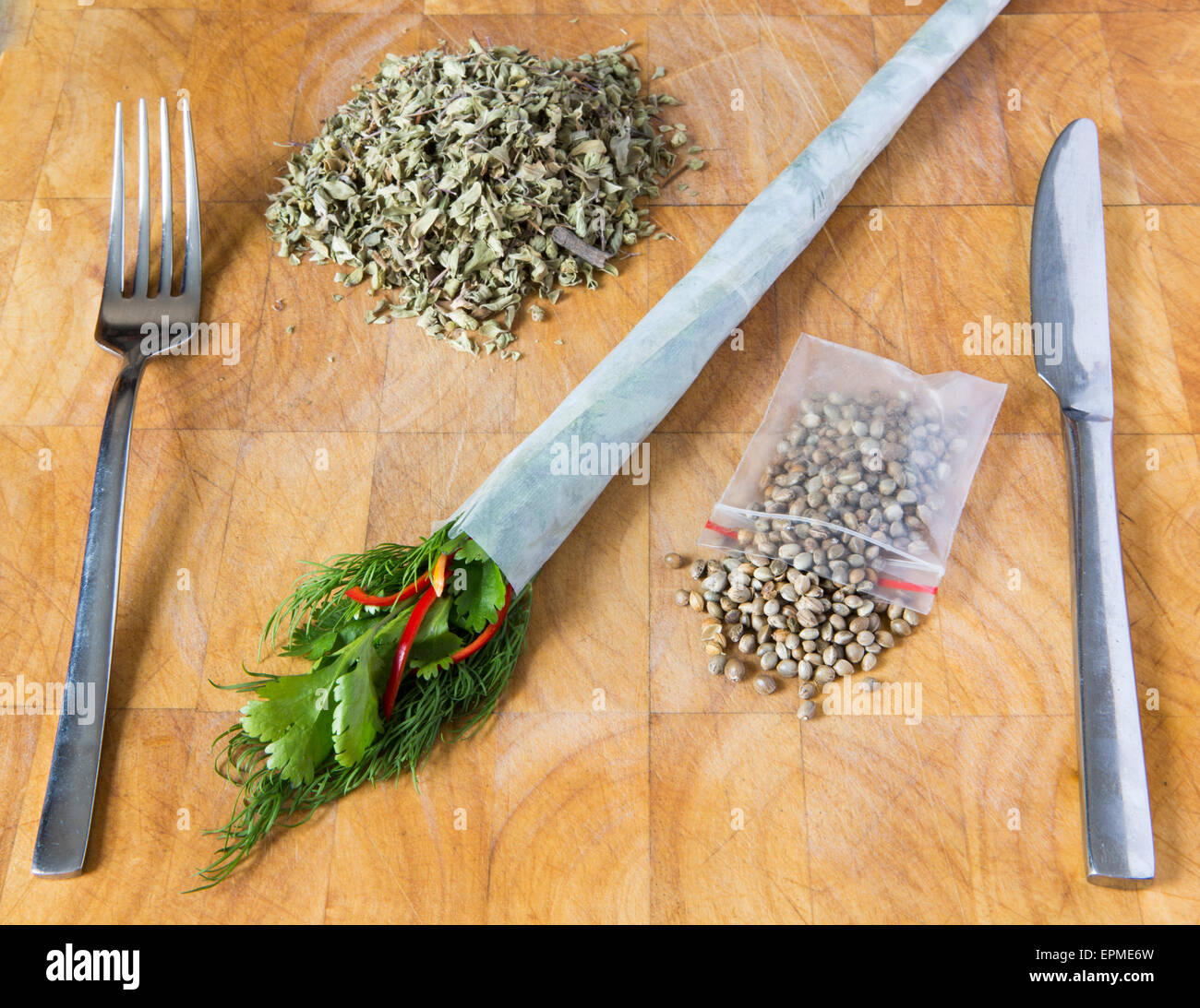 Humorous depiction of a hemp inspired meal featuring hemp seeds, oregano, dill, coriander, rizlas. Stock Photo