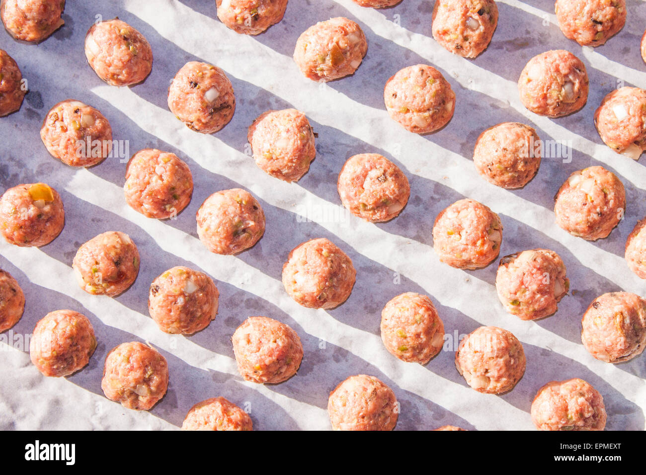 A plate full of pink, raw meatballs Stock Photo Alamy