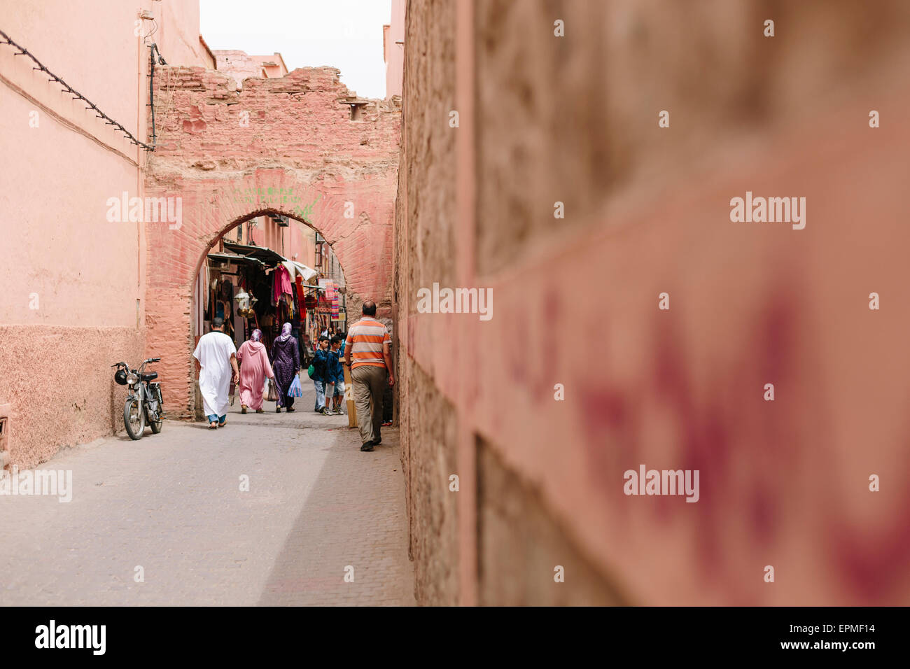 Locals walking through one of the medina gates in the Marrakech old town in Morocco. Stock Photo