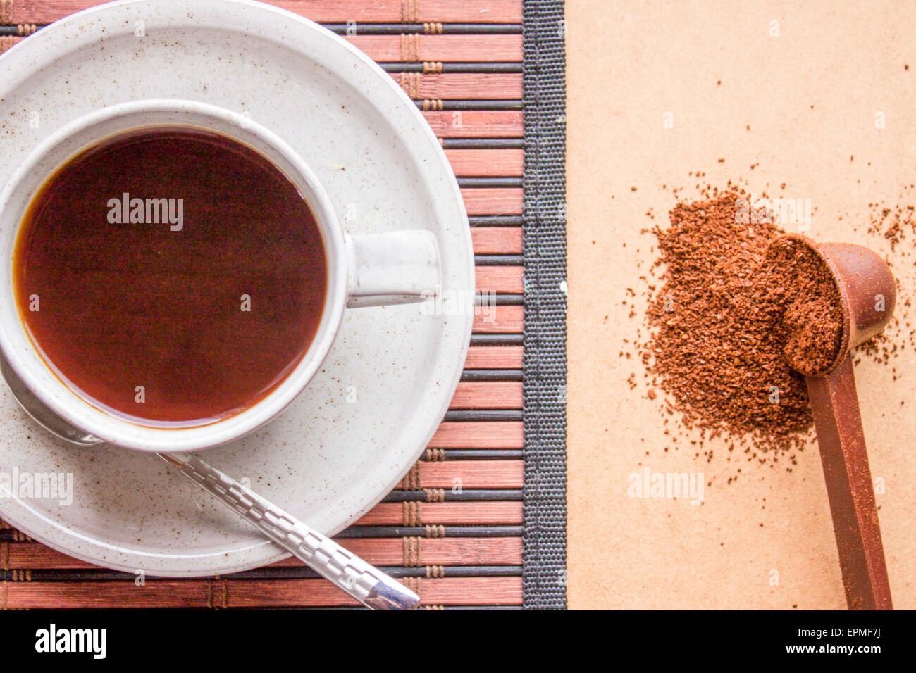 Flavourful dark coffee and minced coffe beans Stock Photo