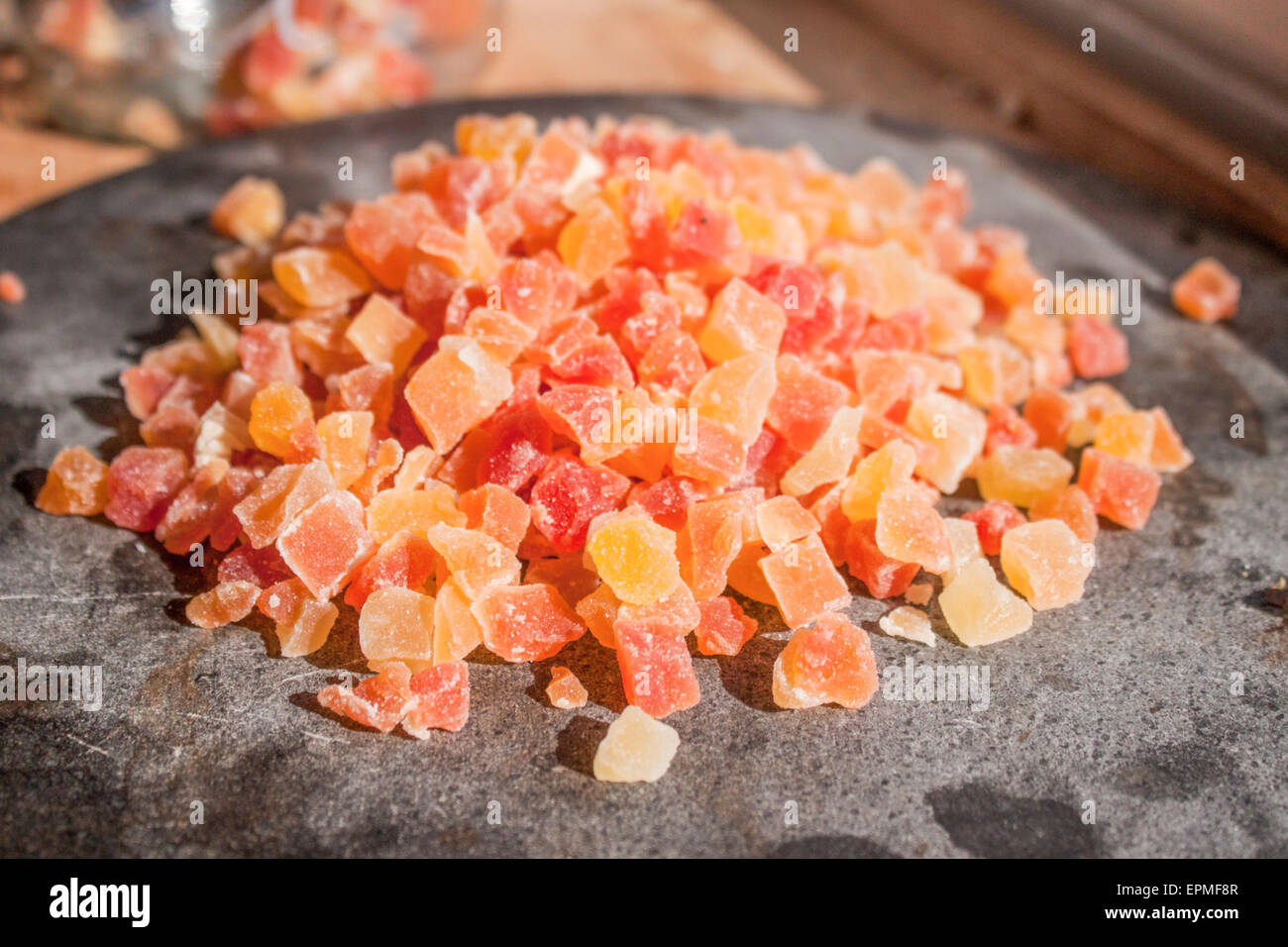 Orange and red dried papayas on a stone plate Stock Photo