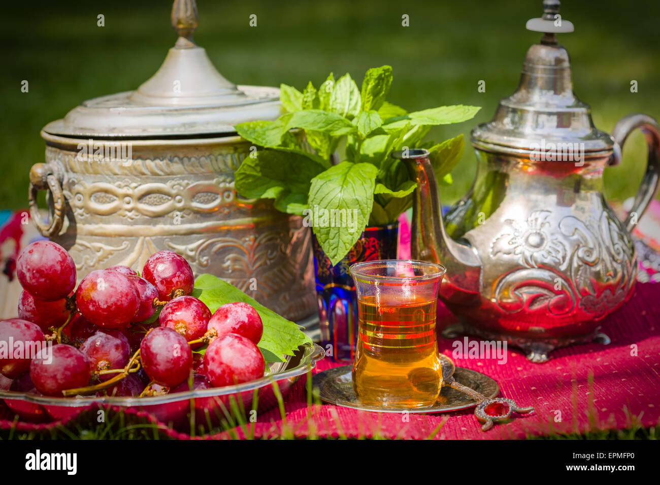 Oasis dream with mint tea and red grapes Stock Photo - Alamy