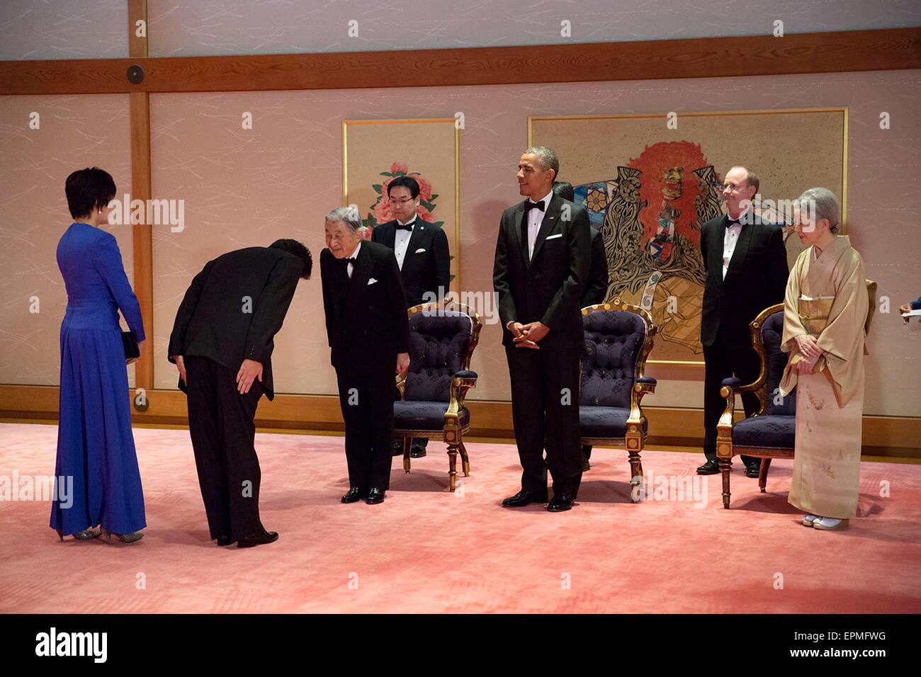 Japanese Prime Minister Shinzo Abe and wife Akie Abe bow as they greet Emperor Akihito as U.S. President Barack Obama and Empress Michiko look on prior to a state dinner at the Imperial Palace April 24, 2104 in Tokyo, Japan. Stock Photo