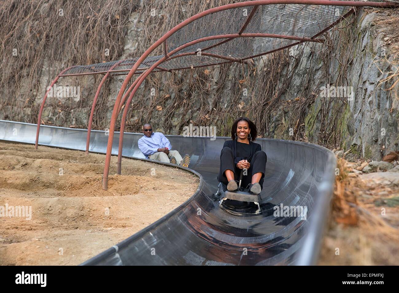 First Lady Michelle Obama rides a toboggan slide at the Great Wall of China March 23, 2014 in Mutianyu, China. Stock Photo
