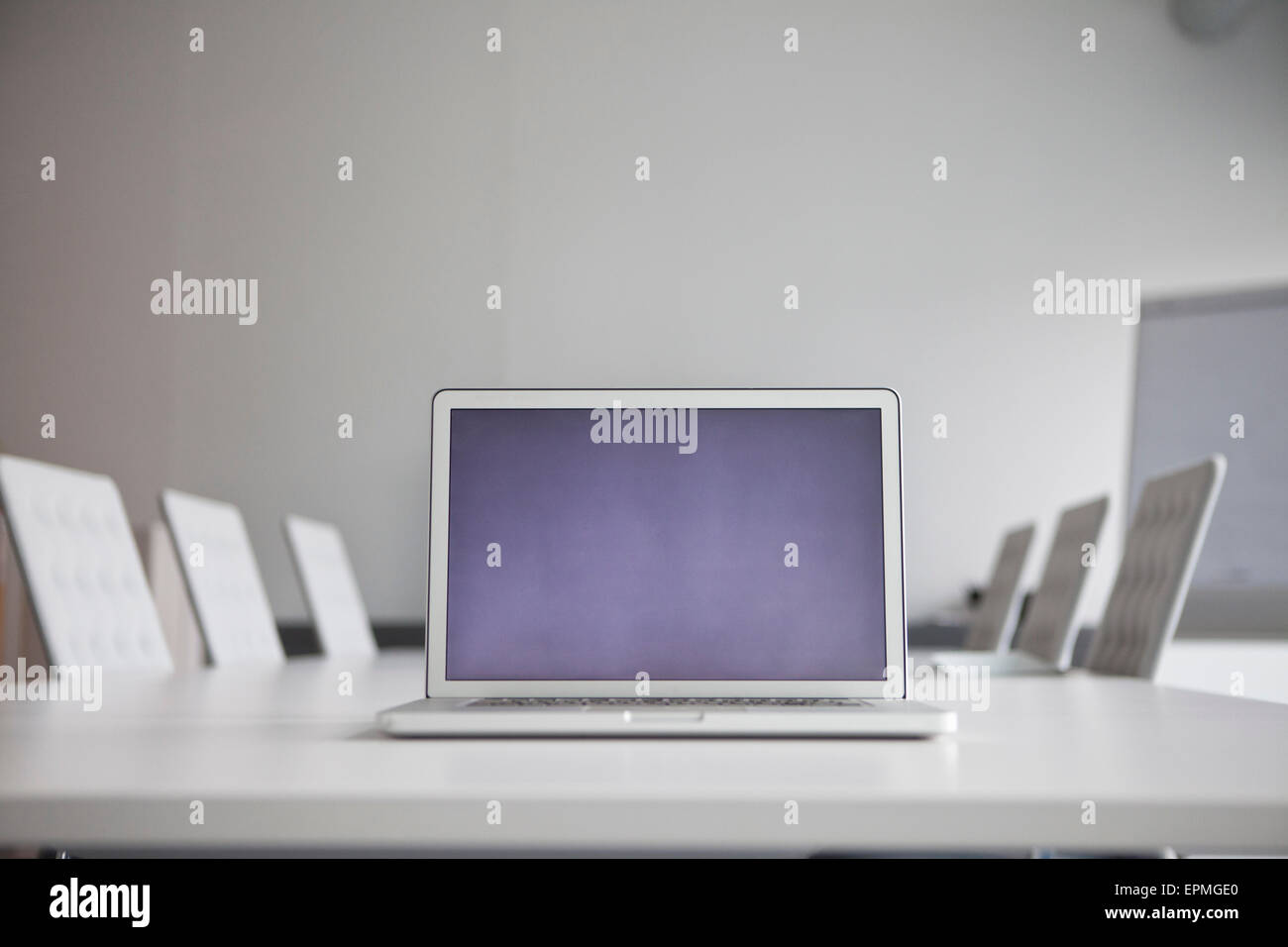 Opened laptop standing on conference table Stock Photo