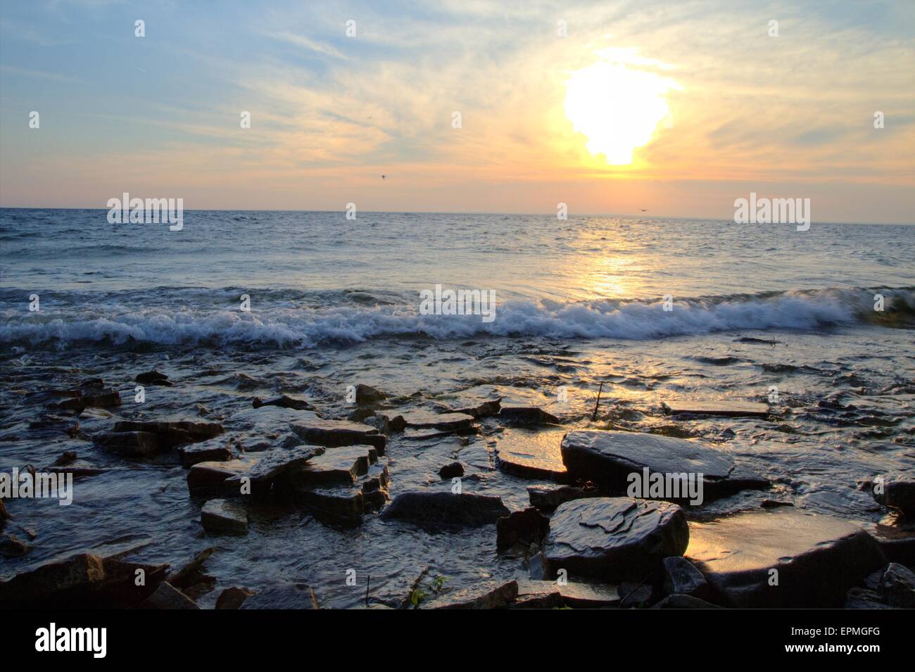 Rocky shore with sunset hi-res stock photography and images - Alamy