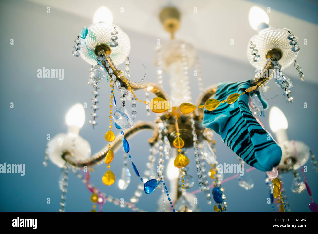 Sock hanging on chandelier after a party Stock Photo