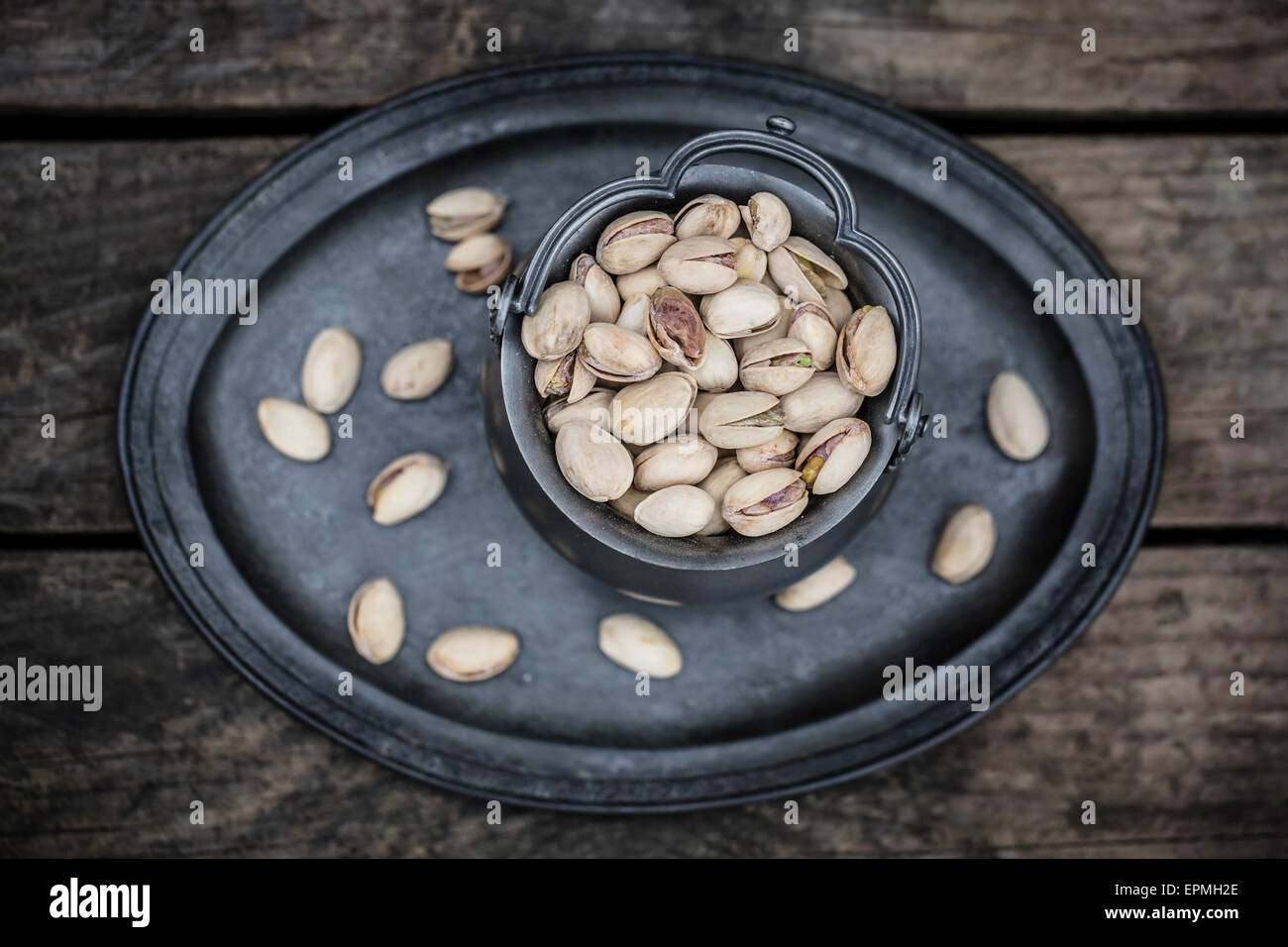 Zinc vessel of pistachios on zinc tray Stock Photo Alamy