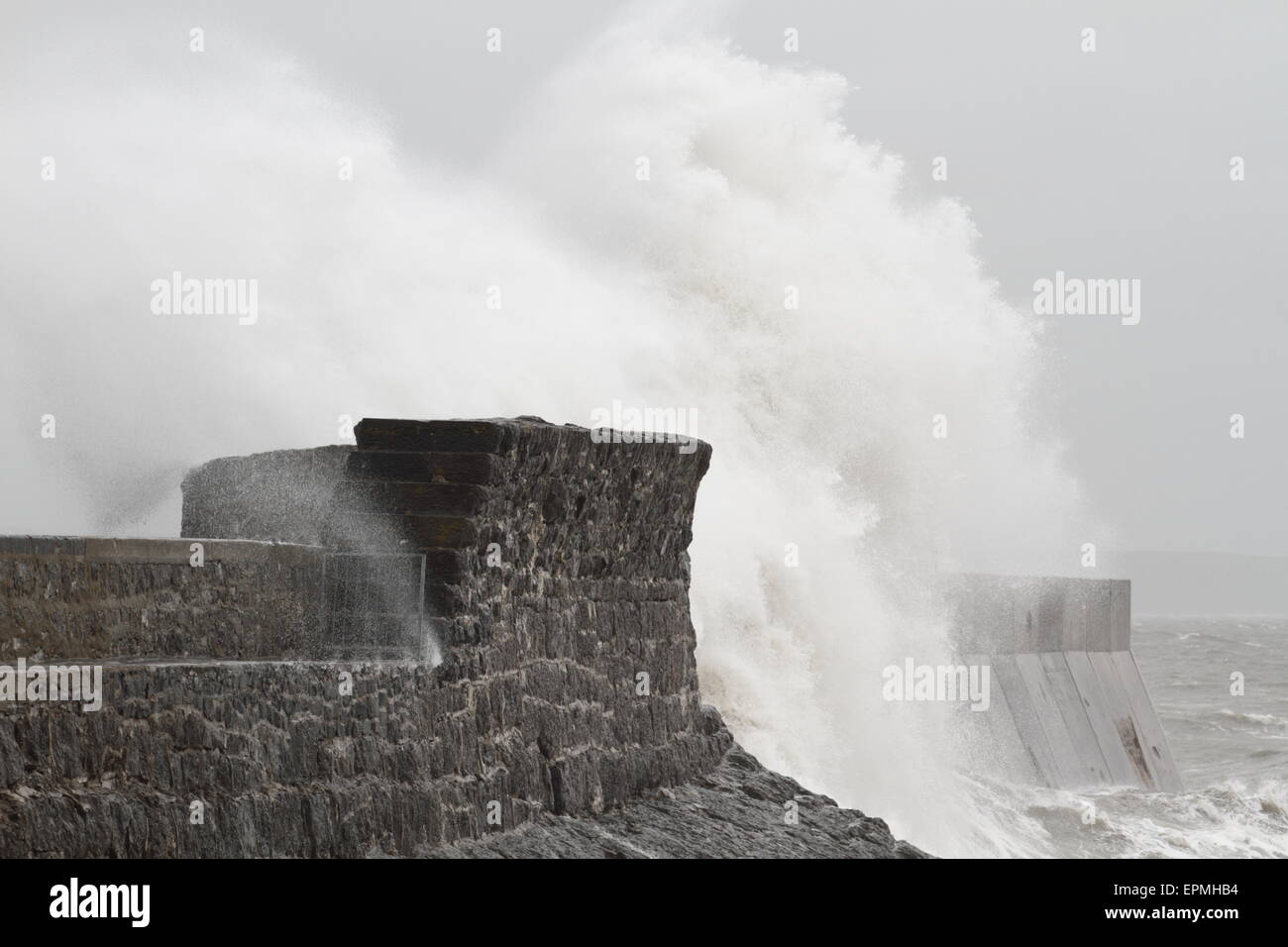 Porthcawl lighthouse, South Wales, UK, taking a battering by the sea in a storm. Stock Photo