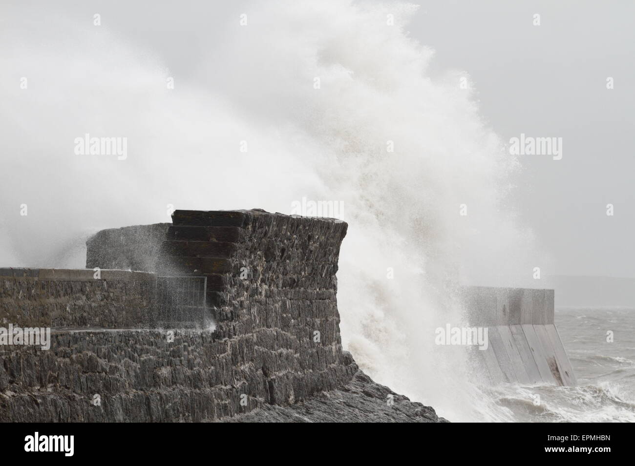 Porthcawl lighthouse, South Wales, UK, taking a battering by the sea in a storm. Stock Photo