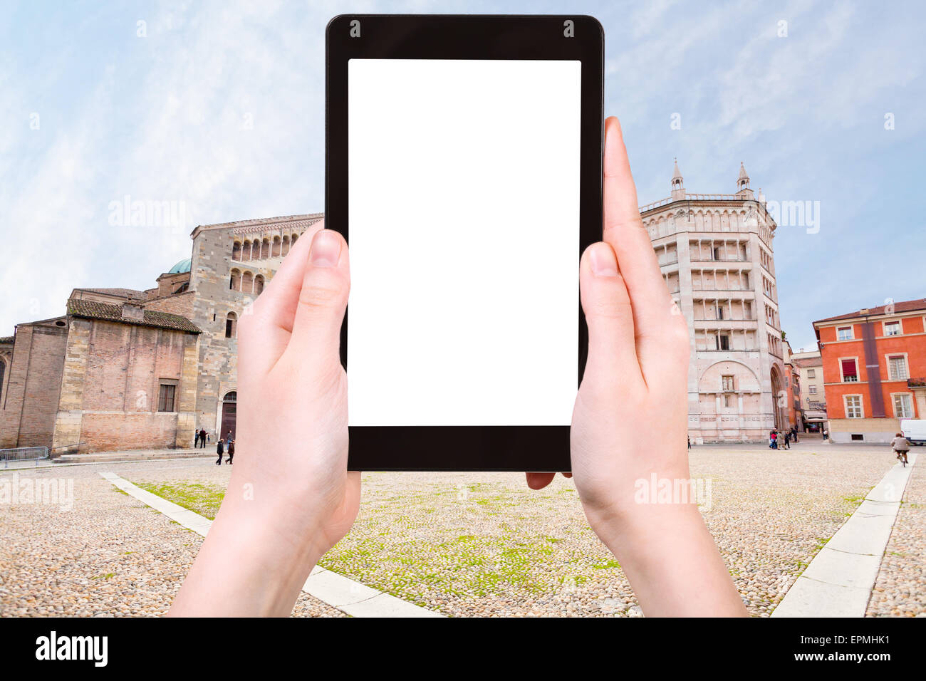 travel concept - tourist photograph Cathedral, the Baptistery on Piazza del Duomo, Parma, Italy on tablet pc with cut out screen Stock Photo