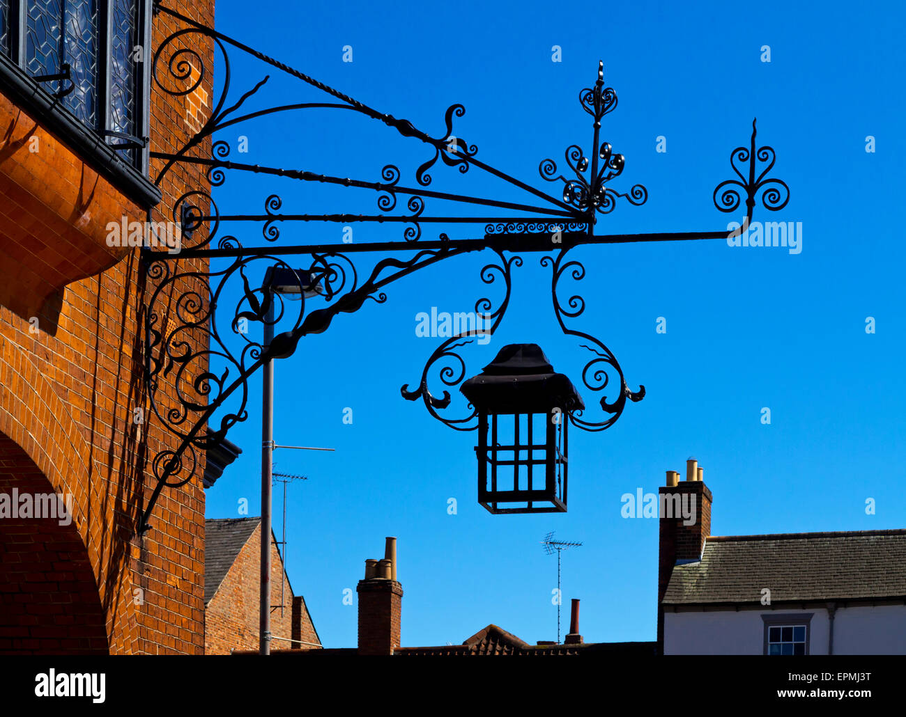 Ornate wrought iron lamp attached to a building in Newark on Trent in Nottinghamshire England UK Stock Photo