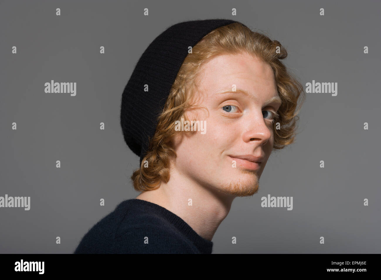 Portrait of smiling young man wearing cap Stock Photo