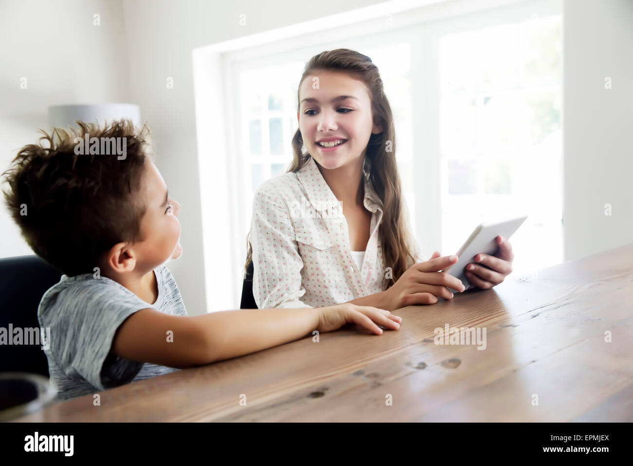Brother and sister using digital tablet Stock Photo - Alamy