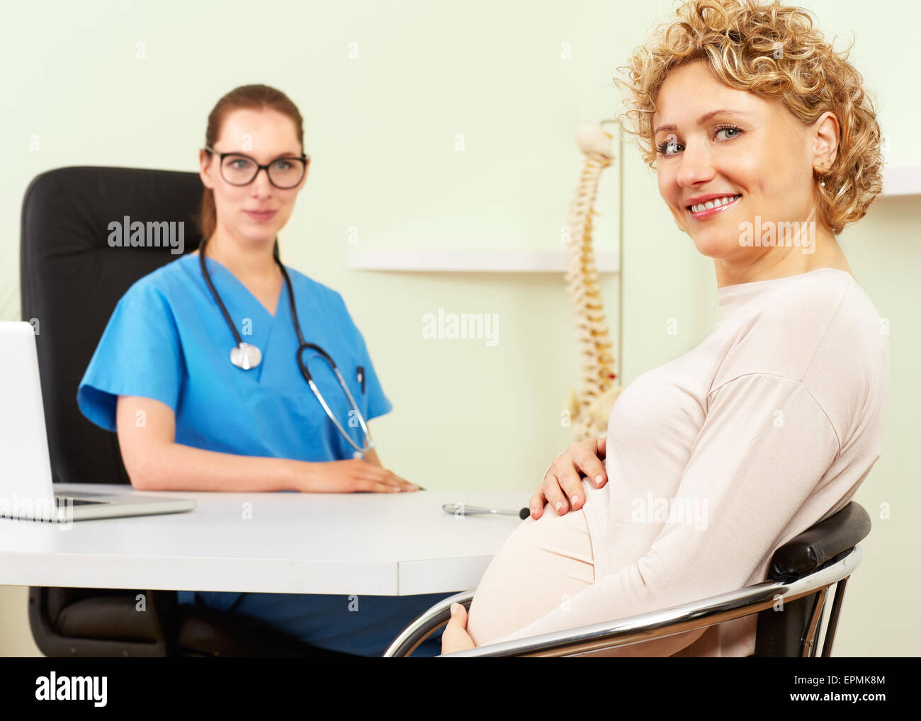 Woman doctor with a patient in treatment. Stock Photo