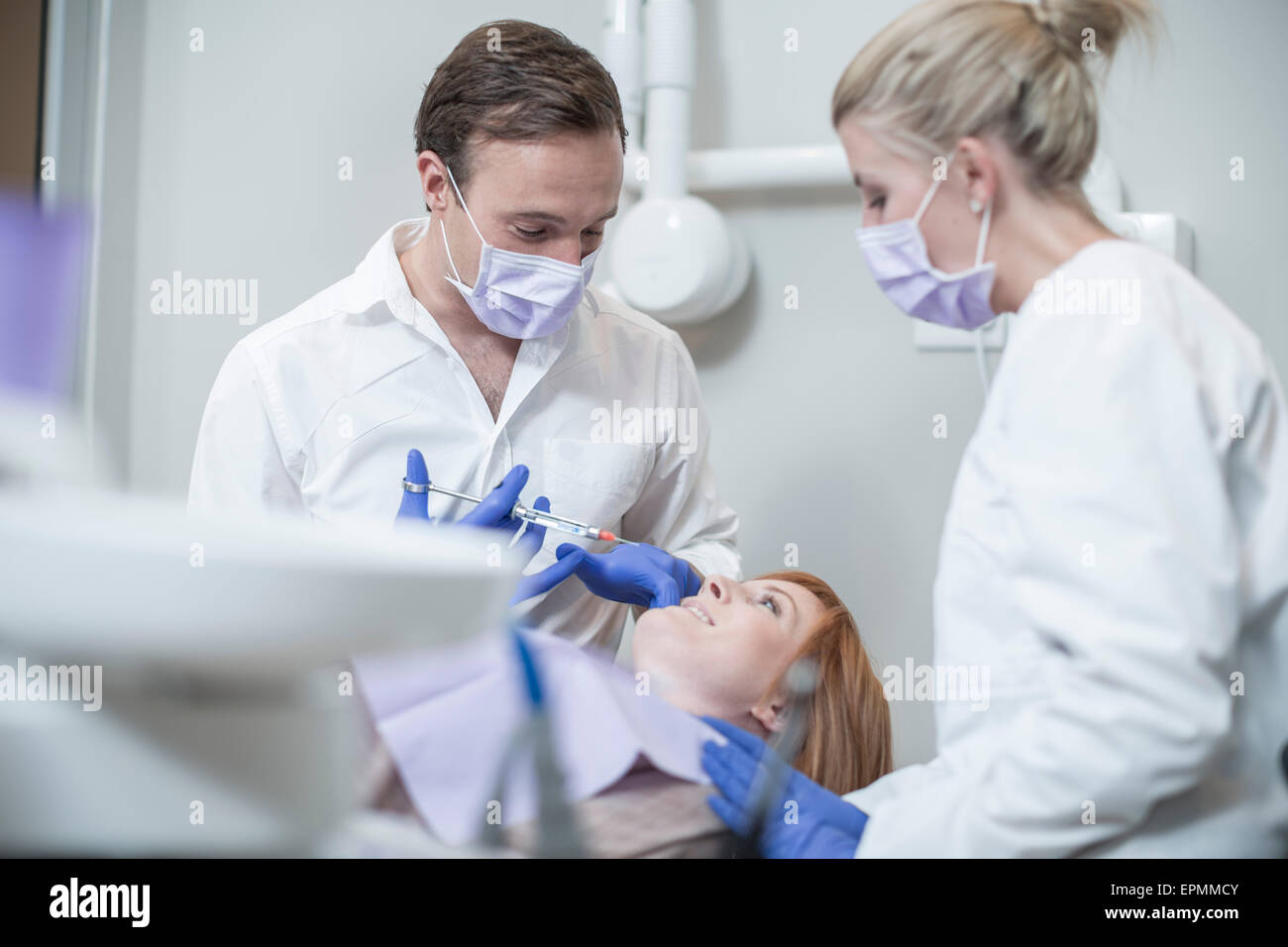 Dentist giving patient injection Stock Photo Alamy