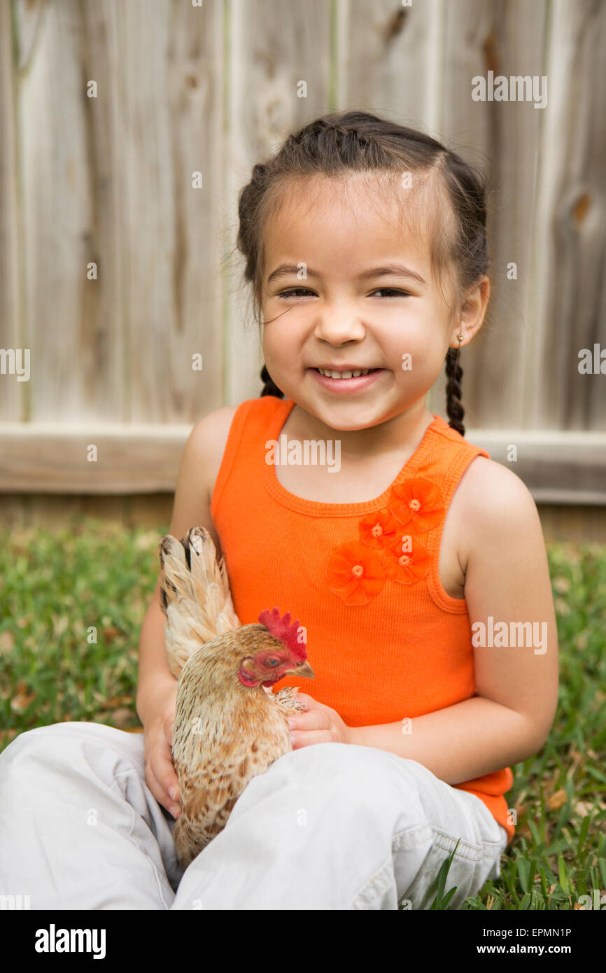 A young girl holding a chicken Stock Photo Alamy