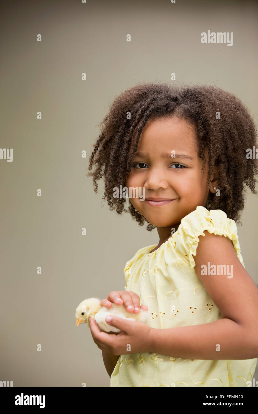 A girl holding a baby chick. Stock Photo