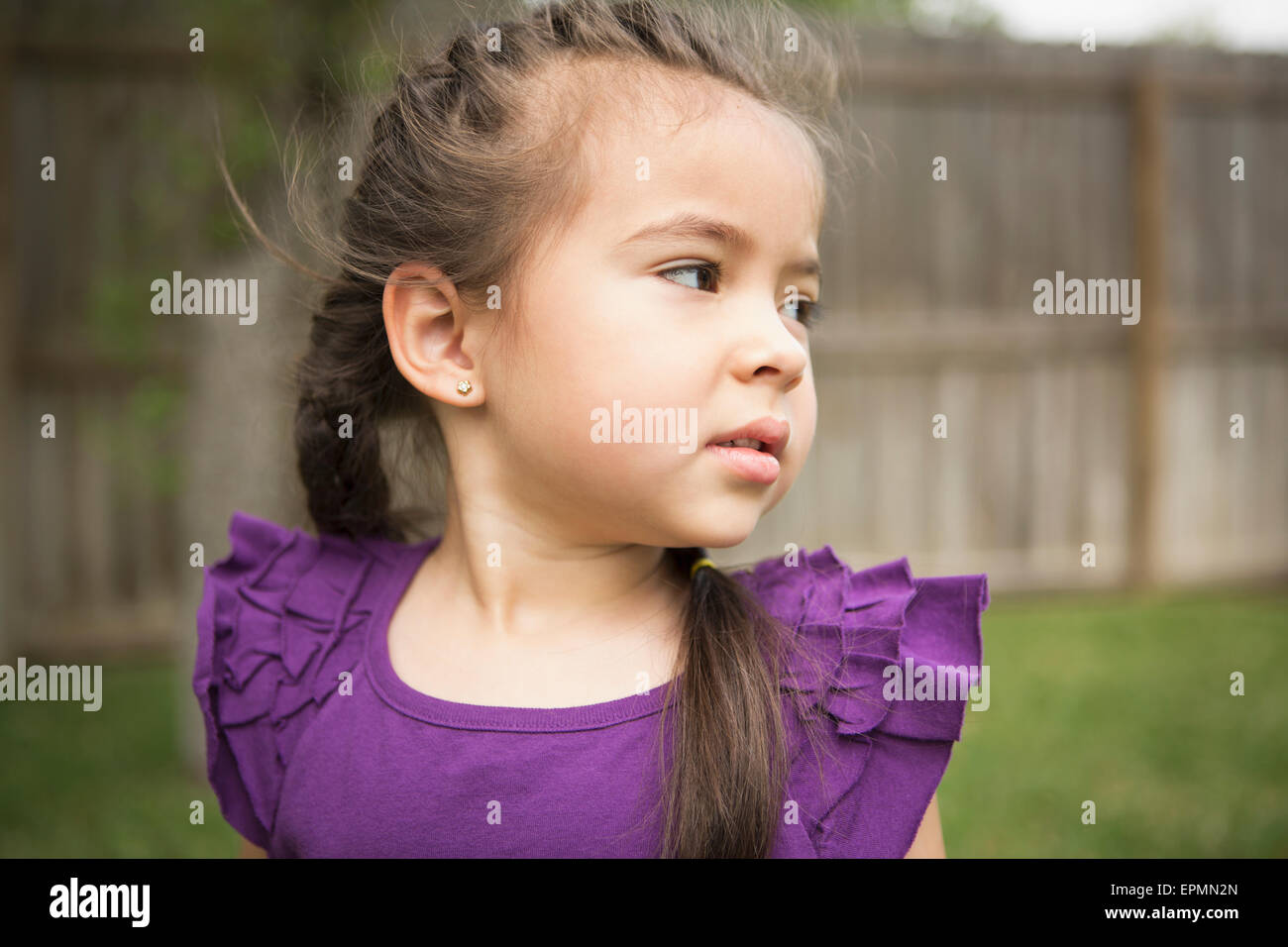 A young girl looking over her shoulder. Stock Photo