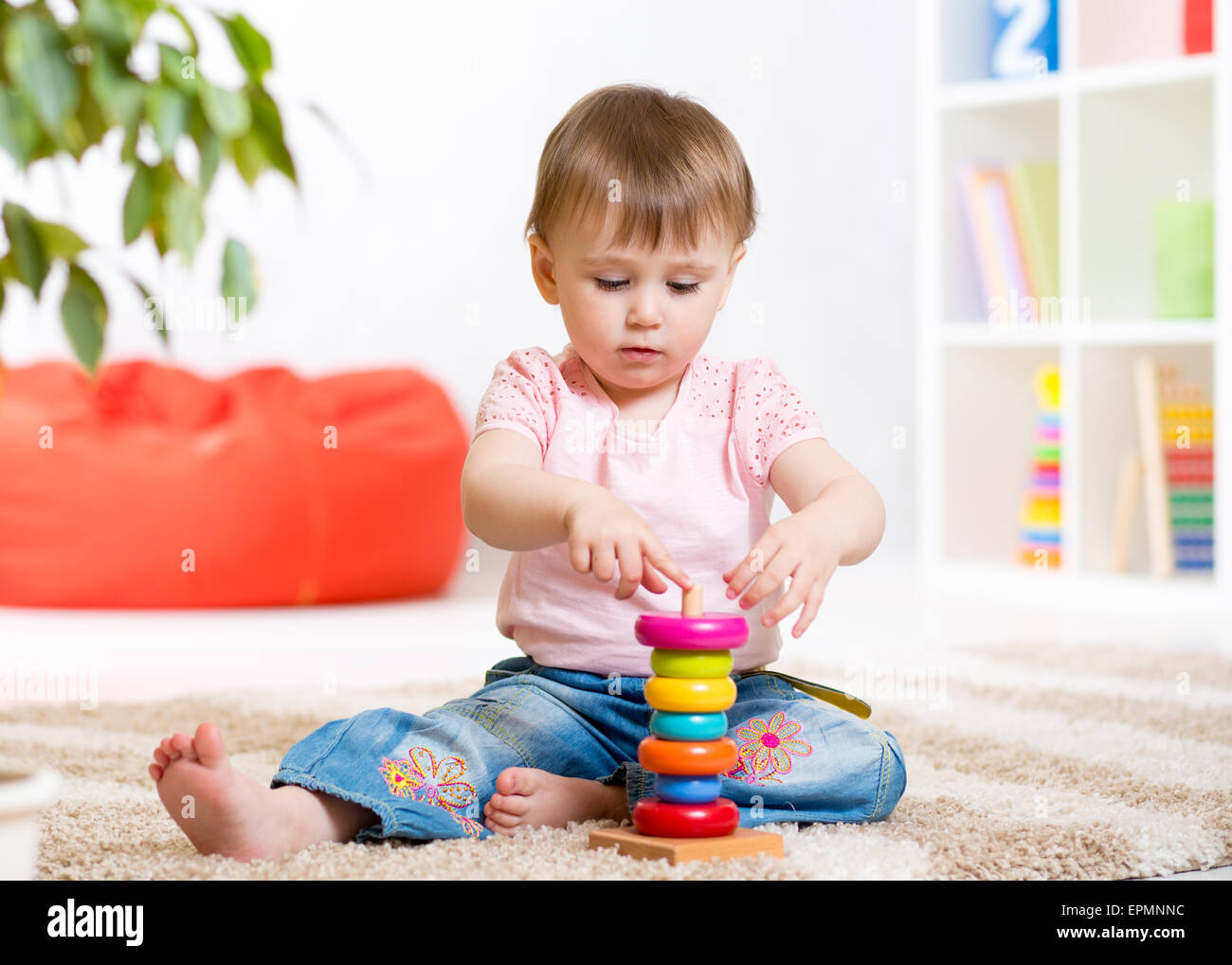 Child girl playing with toy indoors at home Stock Photo - Alamy