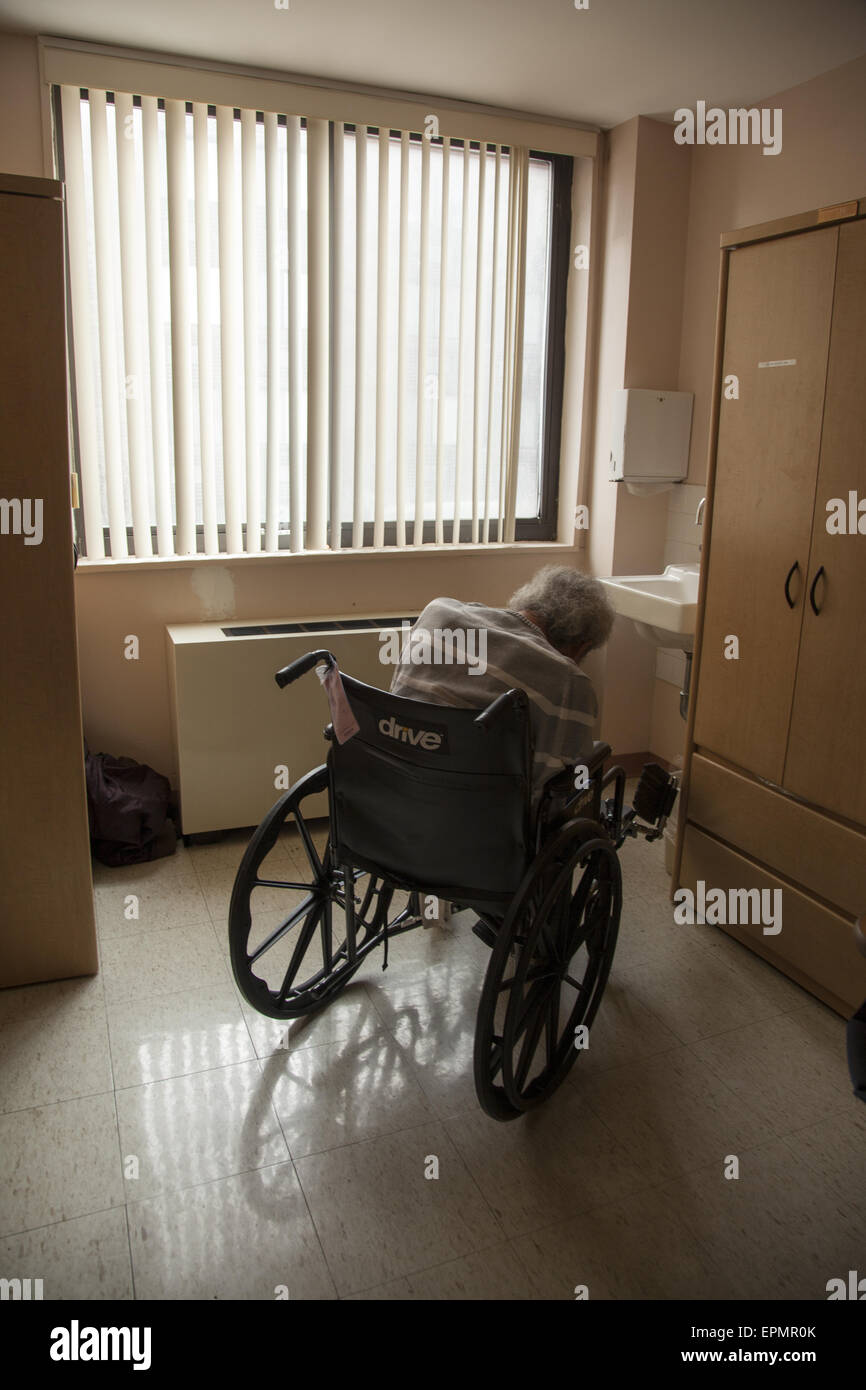 Man with vascular dementia sits alone in a nursing home in New York City. Stock Photo