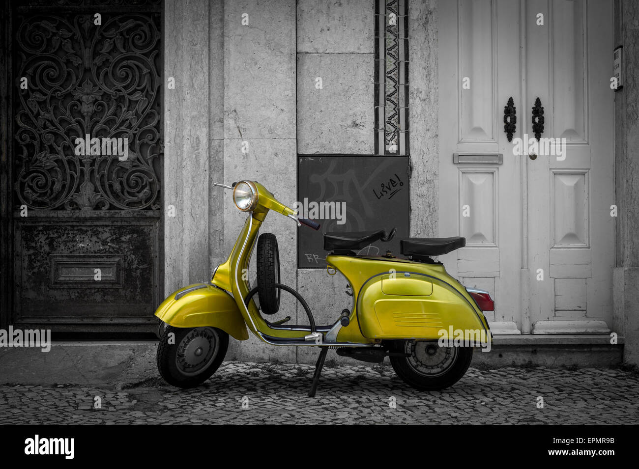 green scooter parked in the street of Lisbon Portugal Stock Photo