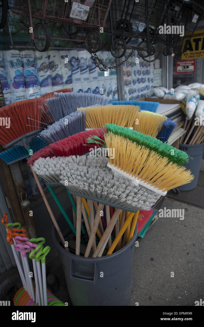 Brooms on display for sale on the sidewalk at a discount store on
