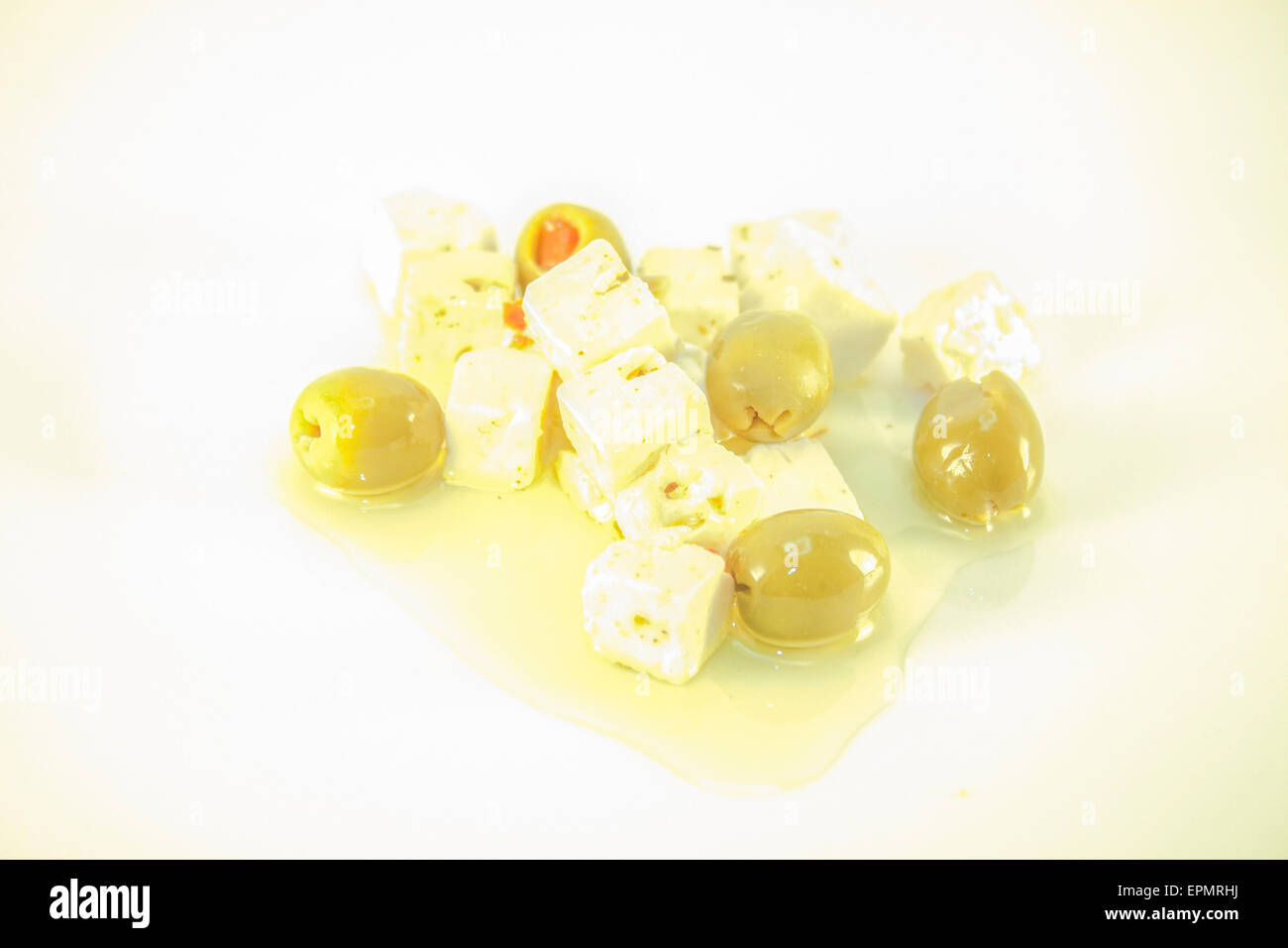 White feta cheese and green olives, isolated on white background Stock Photo
