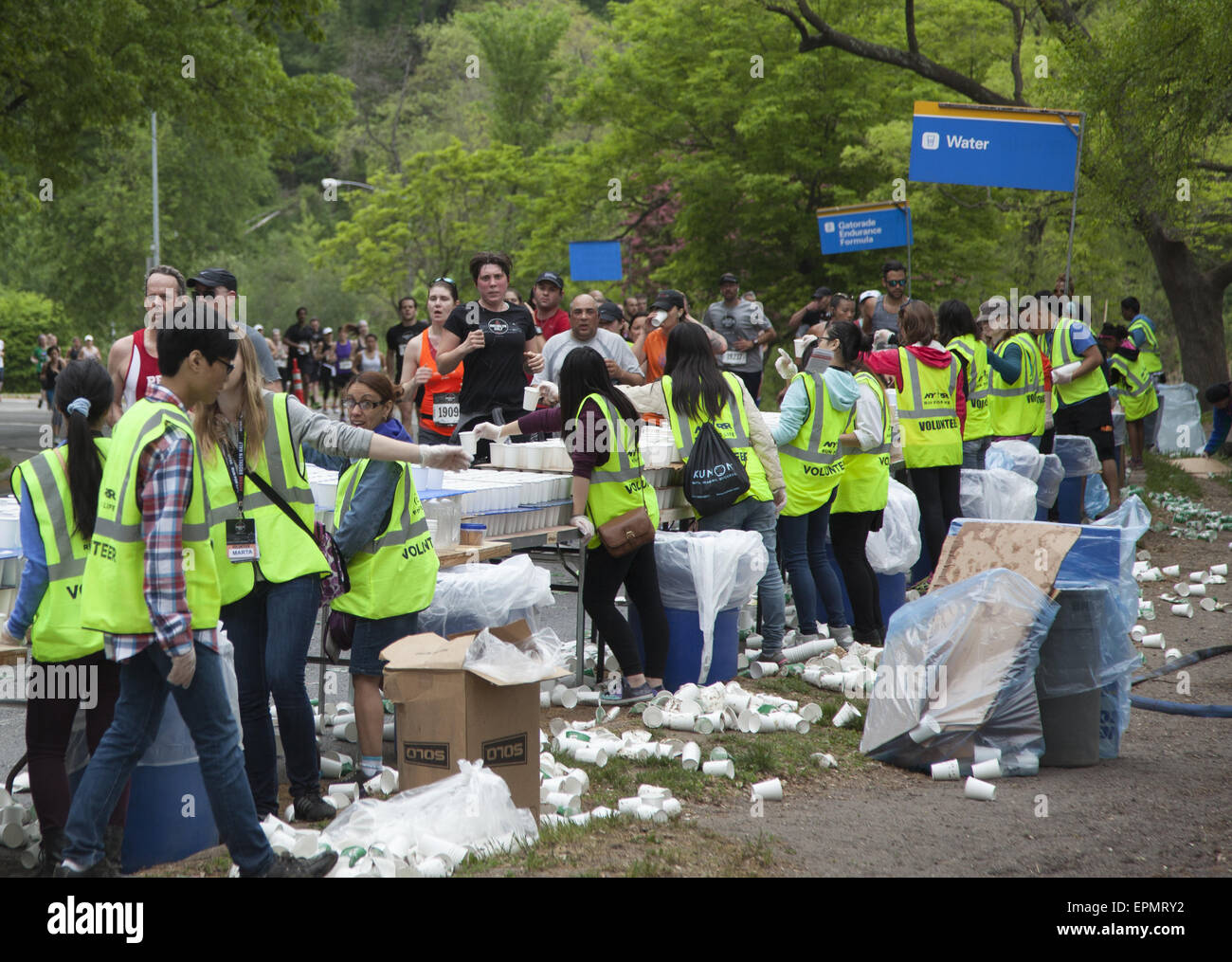 Volunteers give out water to runners at the Brooklyn ½ Marathon in Prospect Park at the halfway point of the race. Stock Photo