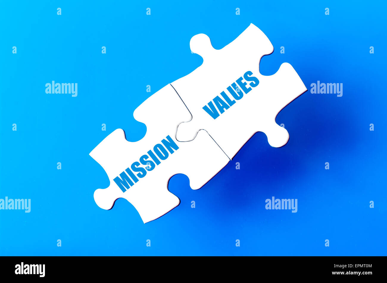 Connected puzzle pieces with words MISSION and VALUES isolated over ...